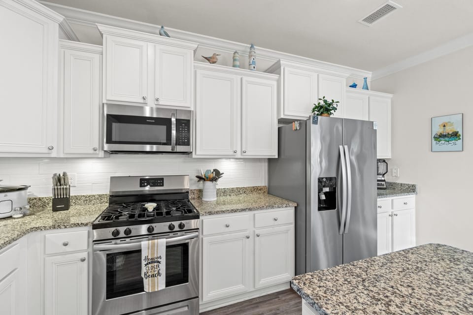 Your fully-equipped kitchen invites culinary adventures with granite countertops, stainless appliances, and thoughtful coastal touches throughout.