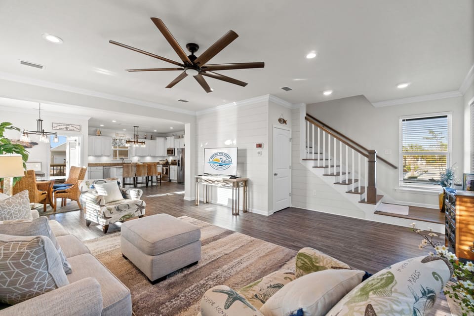 Relax in your spacious living room with soaring ceilings, coastal-inspired décor, and an open flow to the kitchen.