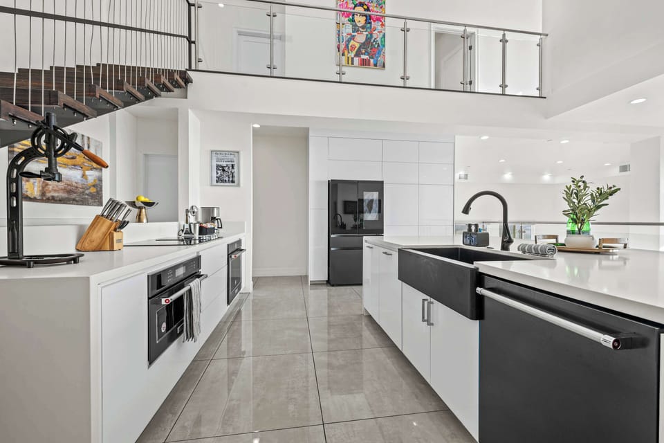 Cook in style in this modern, fully equipped kitchen! Featuring sleek countertops, high-end appliances, and plenty of space to create delicious meals. Perfect for chefs and food lovers alike