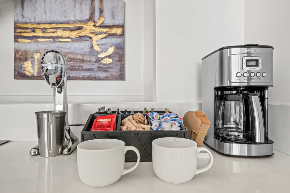 Wake up to the perfect cup!  This cozy coffee corner is stocked with everything you need—freshly brewed coffee, creamers, and sweeteners. Start your day right in this welcoming space!
