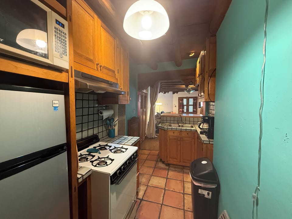 Everything you need: comfy bed, kitchenette, and full bath with vintage flair