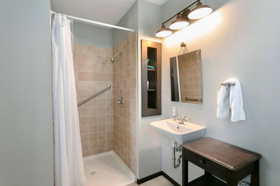 Clean, modern bathroom with walk-in shower and fresh towels