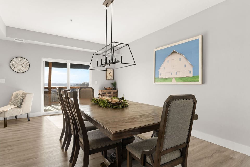 - Gather around the large rustic dining table for family meals or game night
- Charming decor and statement lighting set a warm, inviting scene
- Easy access to the deck makes outdoor dining a breeze
