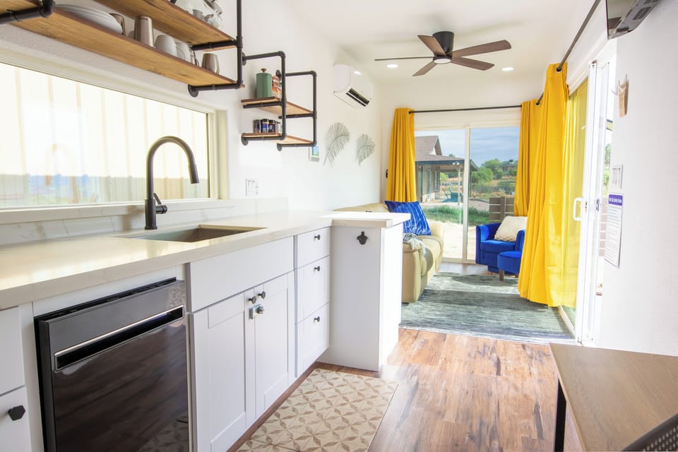 Kitchenette with dishwasher, refrigerator, hot plate, and microwave