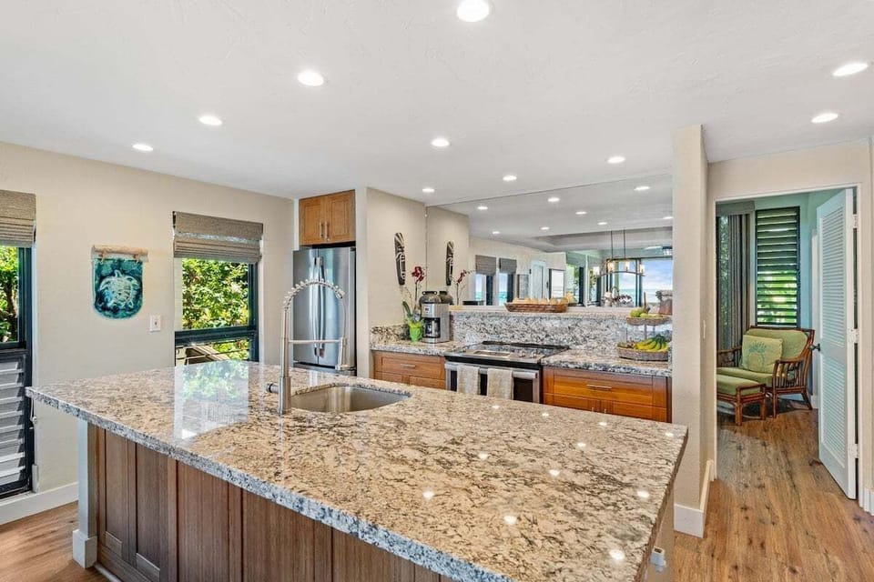 Inviting kitchen design blending functionality and style with a central island and sleek stainless steel appliances.