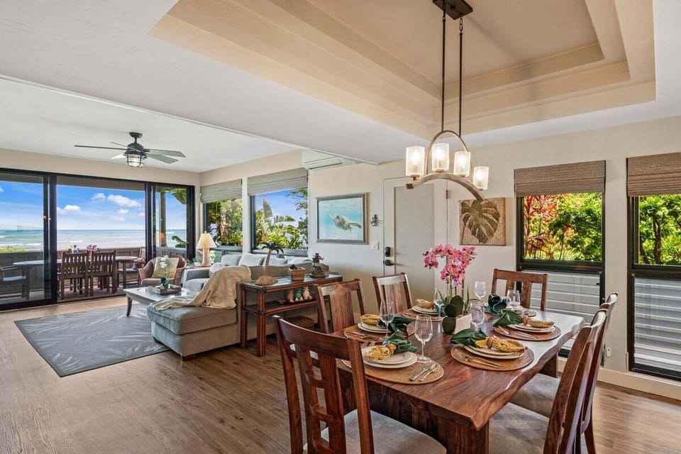 Enjoy meals in this bright dining area featuring tropical decor and a backdrop of blue waters