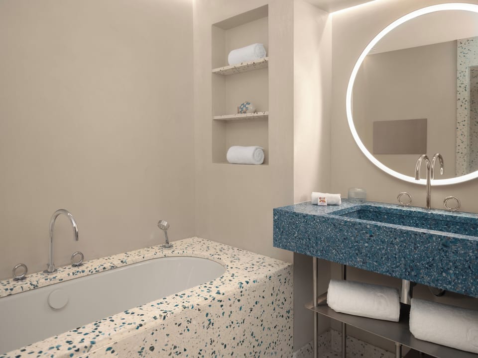 Separate tub and shower, hair dryer, slippers, towels