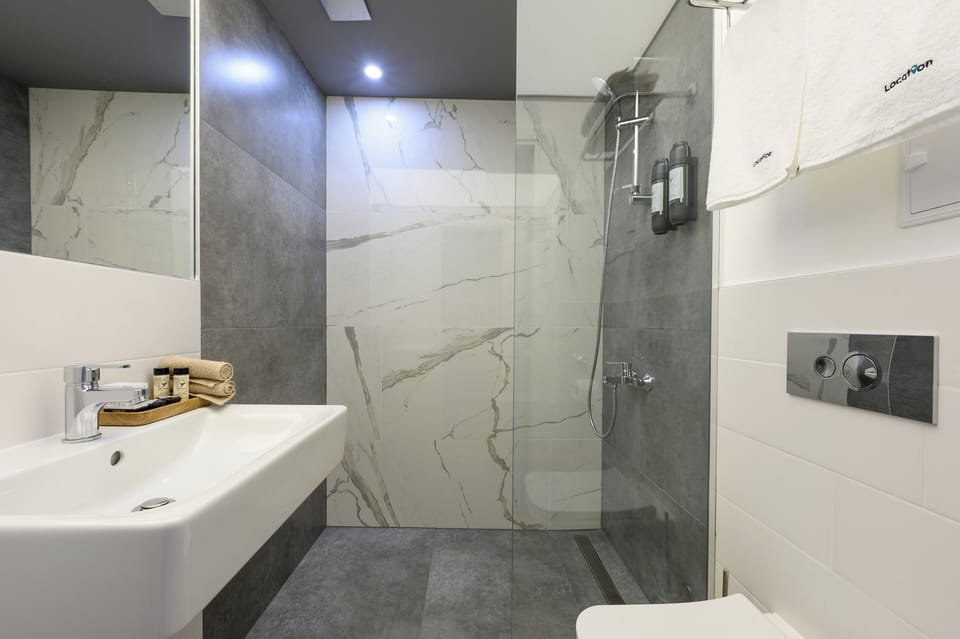 Shower, hair dryer, slippers, towels