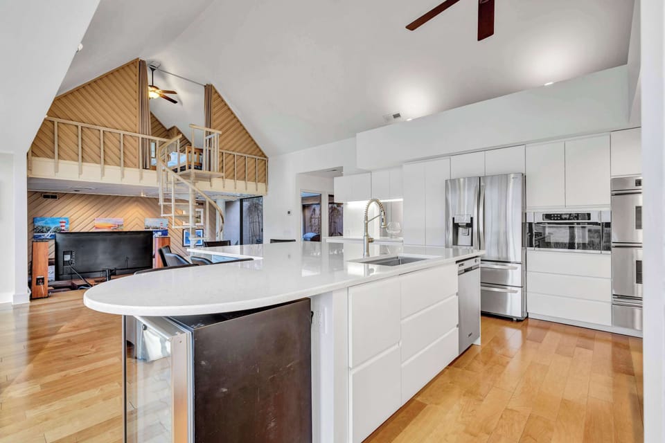 Modern elegance meets functionality in this fully stocked kitchen with sleek white quartz countertops—perfect for cooking, entertaining, or enjoying a quick meal.