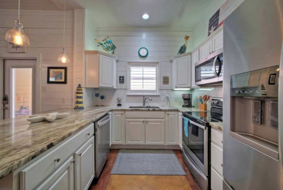 Features a large island, ample cabinetry, and high-end appliances, making it perfect for cooking, entertaining, and gathering with loved ones. 