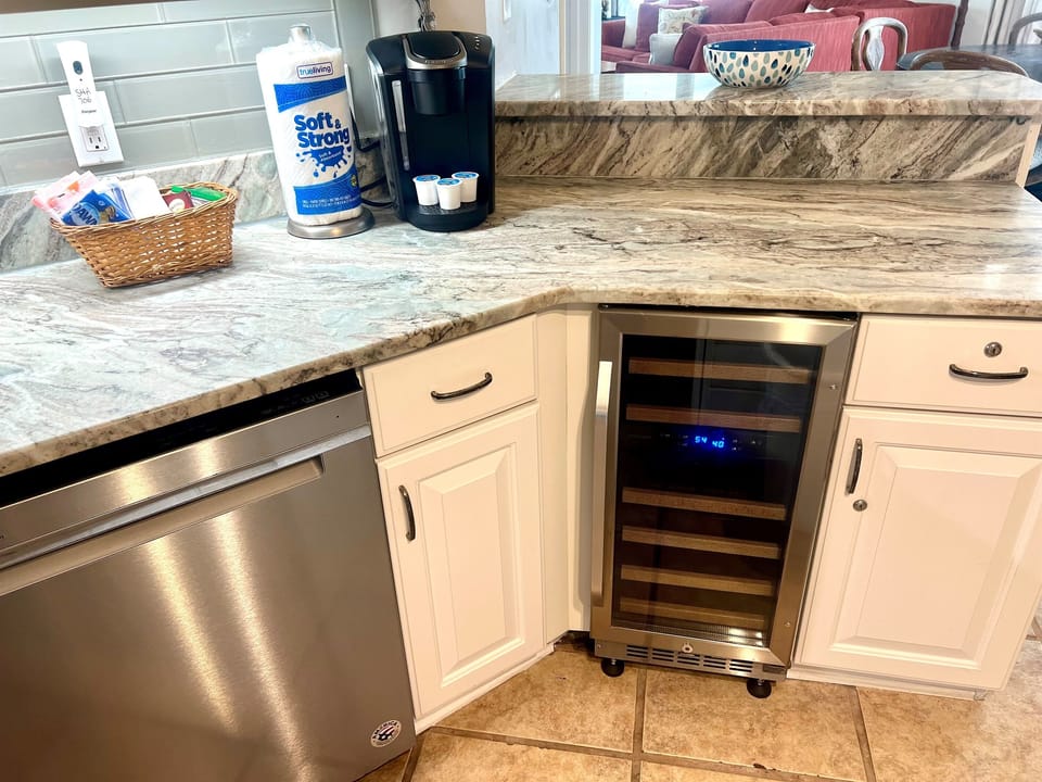 Kitchen is equipped with a wine fridge 