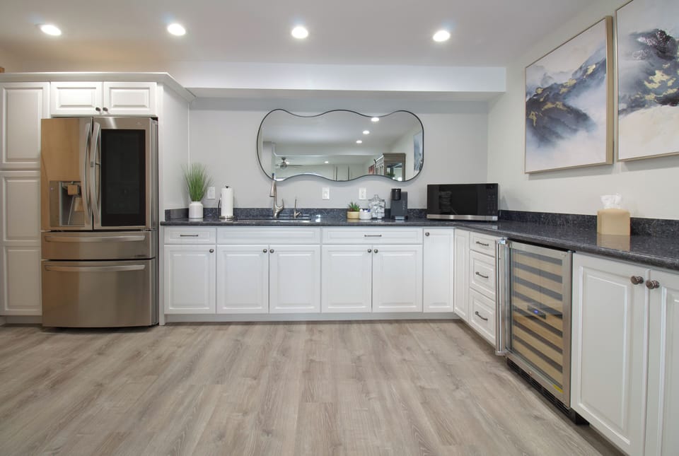 Downstairs kitchenette w/ full sized fridge, Keurig, wine fridge, & microwave.