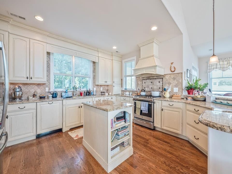 Fully stocked gourmet kitchen with modern appliances, a large island, and plenty of counter space for meal prep.