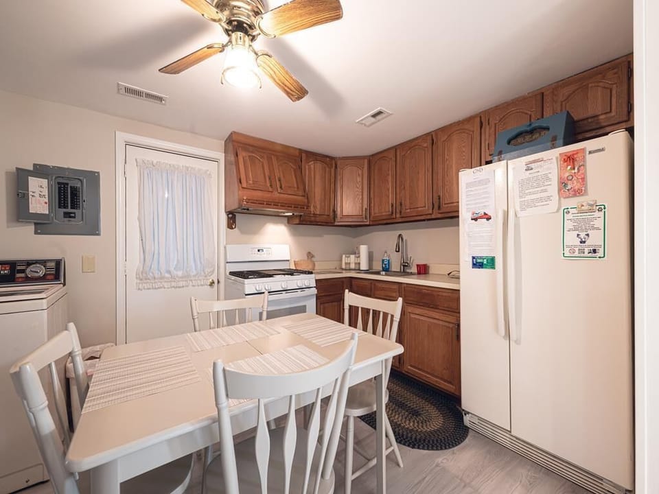 A spacious kitchen showcases warm wooden cabinets and plenty of dining space.