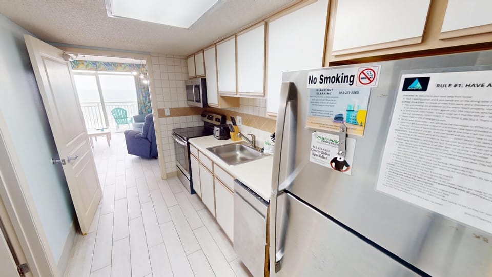 Kitchen - Prepare meals with ease in the fully equipped kitchen featuring a full-size refrigerator, stove, oven, and all the essentials for cooking during your stay.