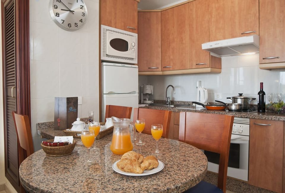 Fridge, microwave, coffee/tea maker, cookware/dishes/utensils