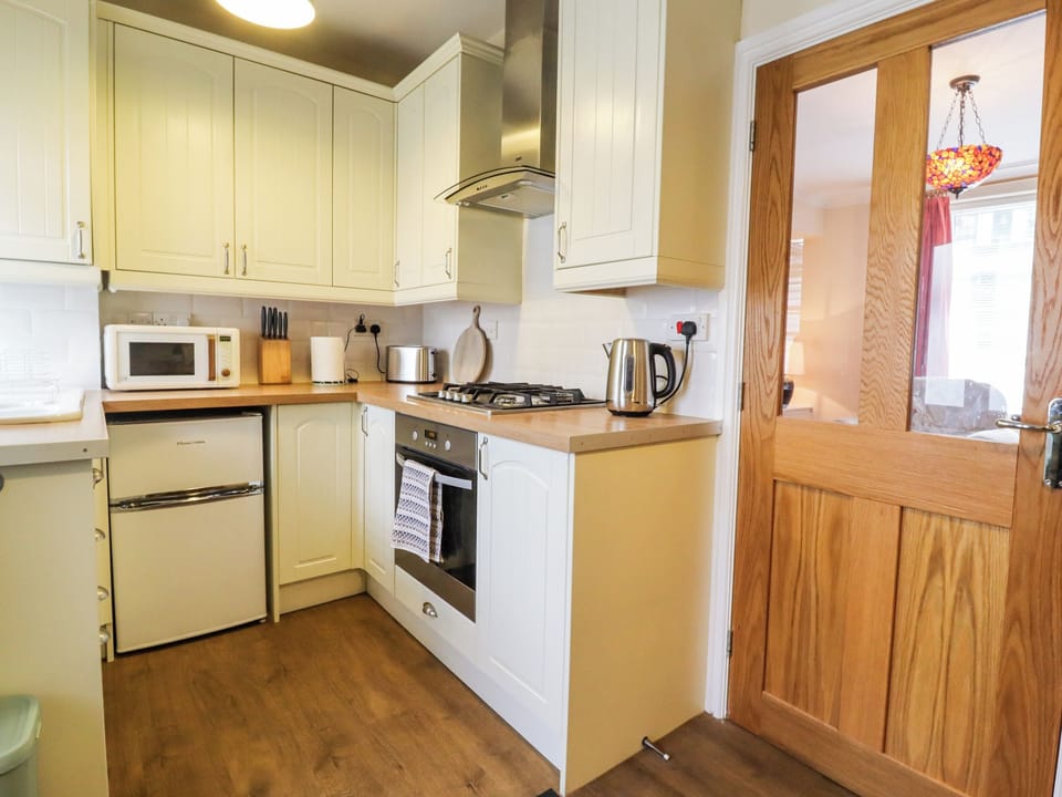 Fridge, electric kettle, toaster, cookware/dishes/utensils