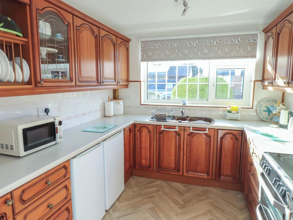 Fridge, electric kettle, cookware/dishes/utensils