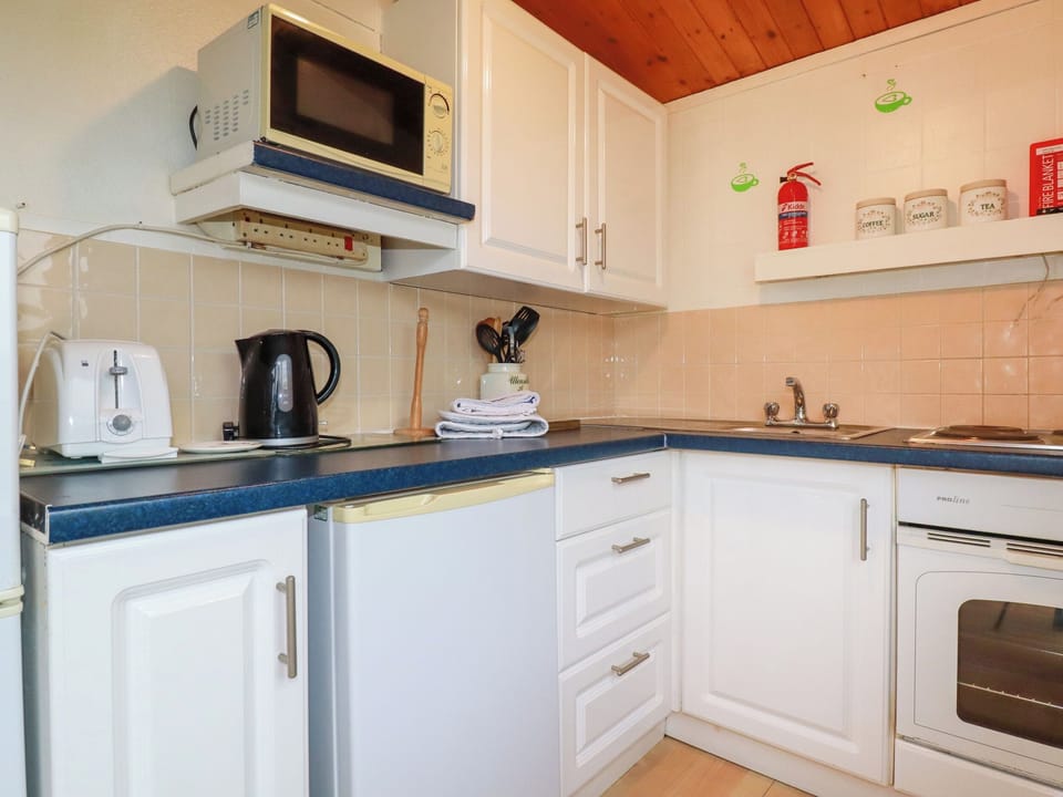 Fridge, electric kettle, cookware/dishes/utensils