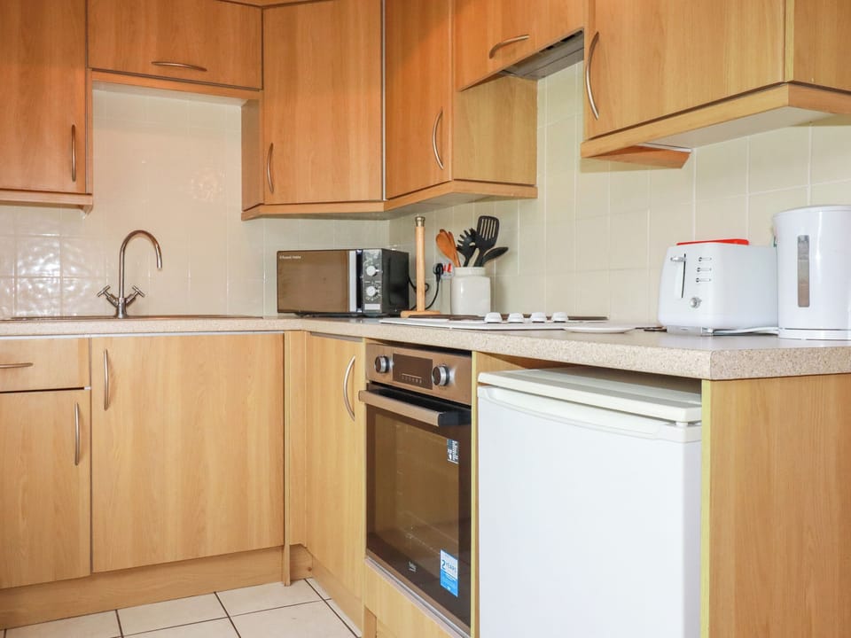 Fridge, electric kettle, cookware/dishes/utensils