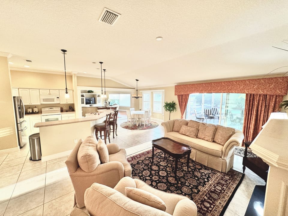 Family Room with Open Concept to the Left and Sliders to the Lanai to the Right