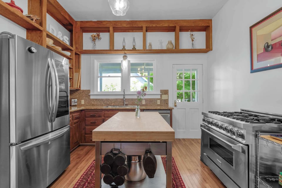 Modern convenience meets vintage soul. Our kitchen is fully updated with a high-end gas range and sleek stainless appliances, perfect for creating gourmet meals at home.