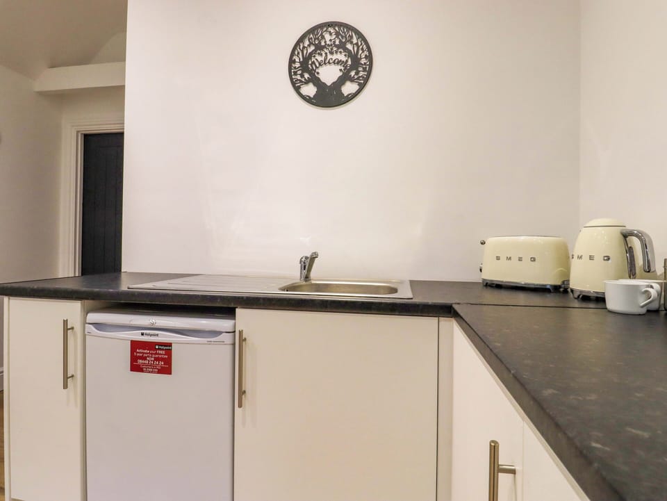Fridge, electric kettle, cookware/dishes/utensils