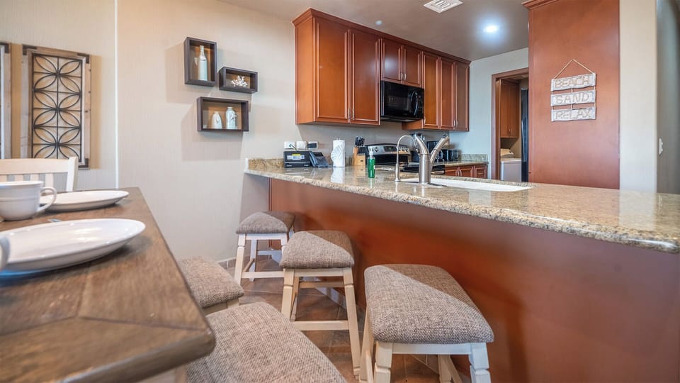 Bar stools along the kitchen counter.