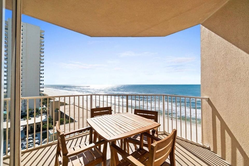 Balcony with dining table and coastal views