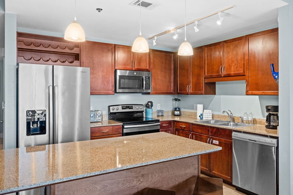 Modern kitchen with stainless steel appliances and a spacious island.