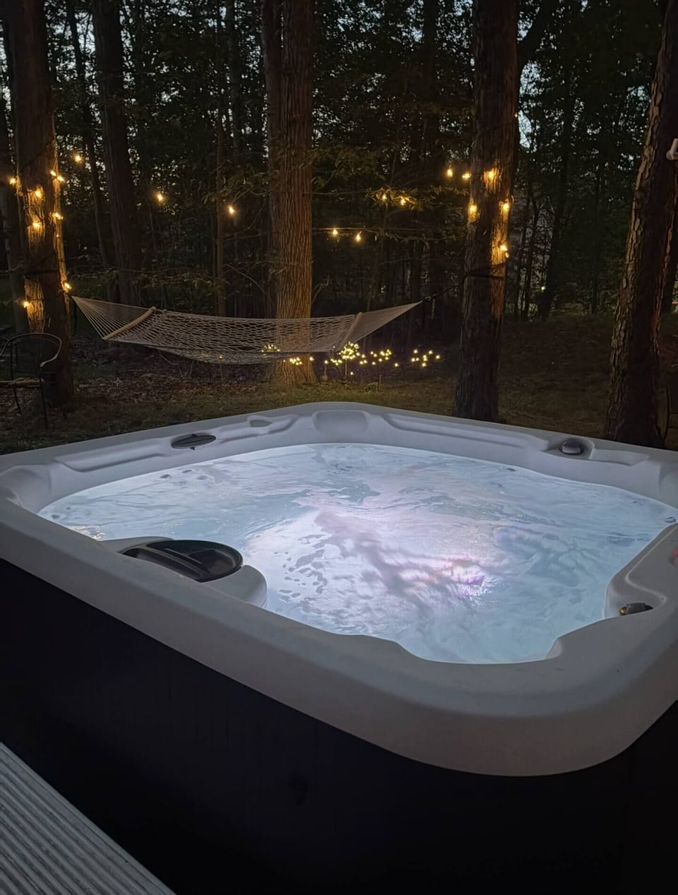 Nighttime view of hammock and hot tub