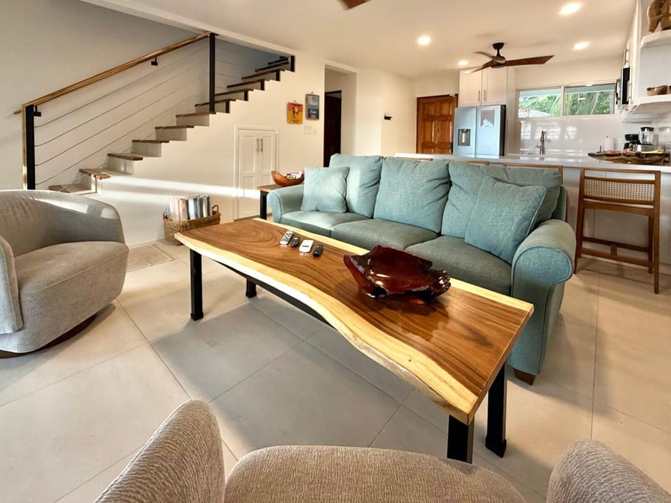 Spacious living area with downstairs 1/2 bathroom and sliding door to patio
