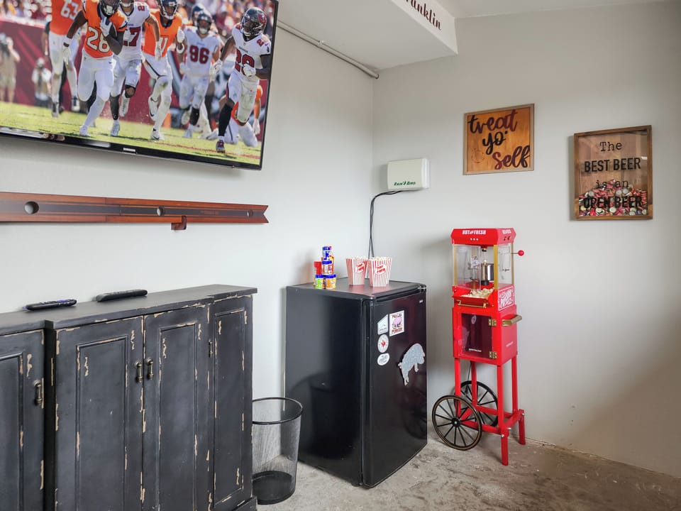 There’s a popcorn machine and a mini fridge for ultimate Game Night snacks.