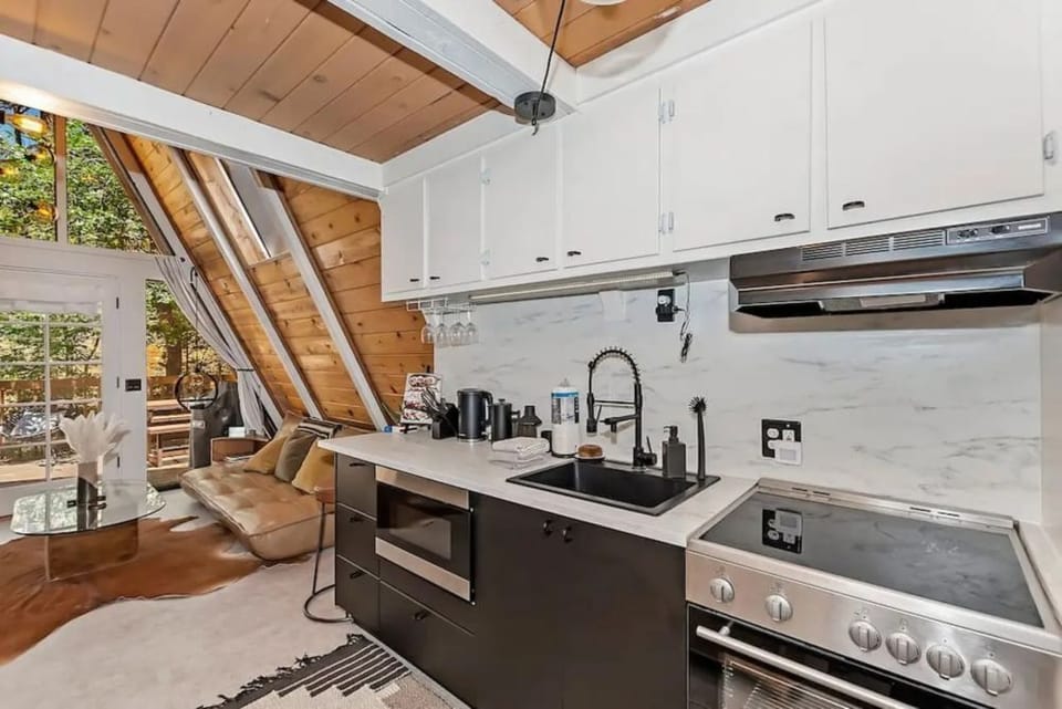 Kitchen stocked with essentials needed to enjoy your stay. Pots, Pans, utensils, silverware.