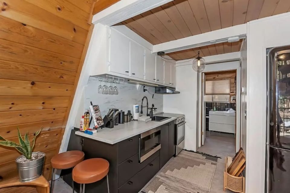 Kitchen stocked with essentials needed to enjoy your stay. Pots, Pans, utensils, silverware.