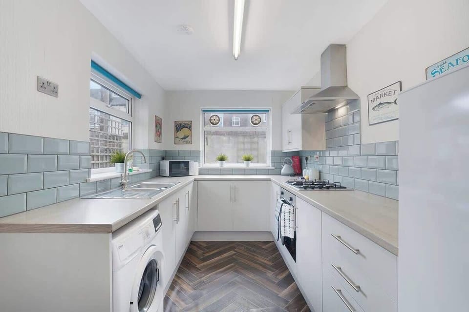 Kitchen equipped with all essentials, including a washer & dryer, oven, fridge and full cookware set.