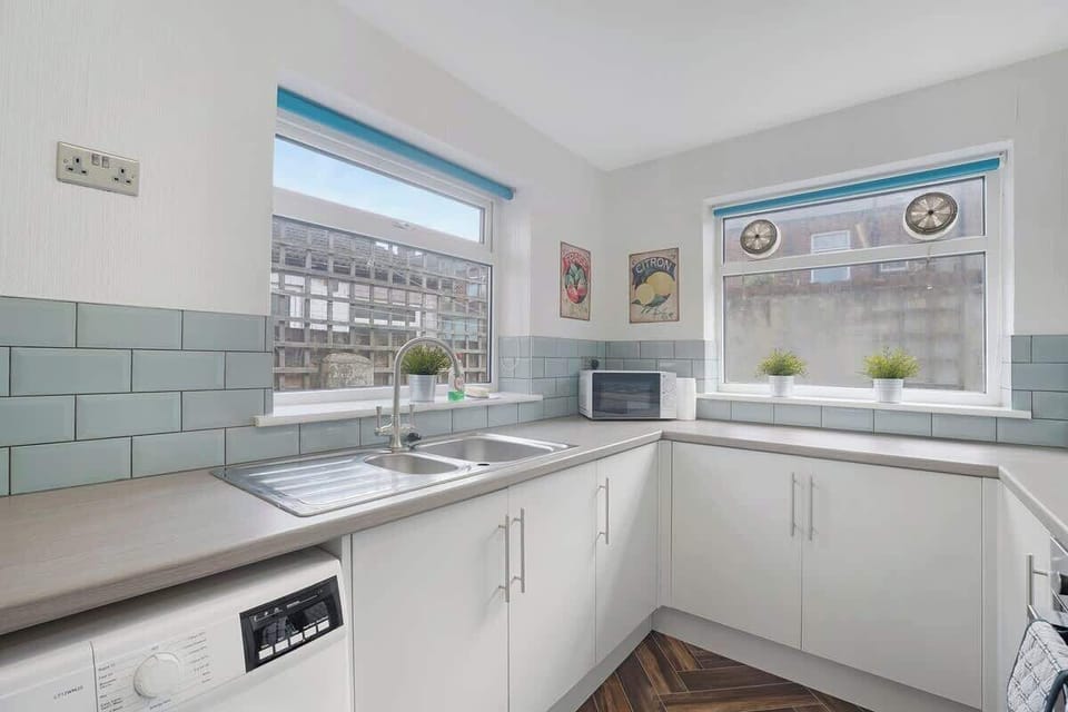 Kitchen equipped with all essentials, including a washer & dryer, oven, fridge and full cookware set.