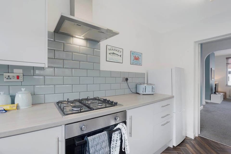 Kitchen equipped with all essentials, including a washer & dryer, oven, fridge and full cookware set.