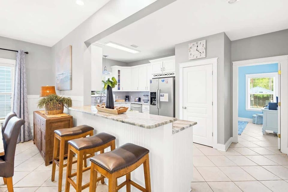 Kitchen island includes additional seating for 3.