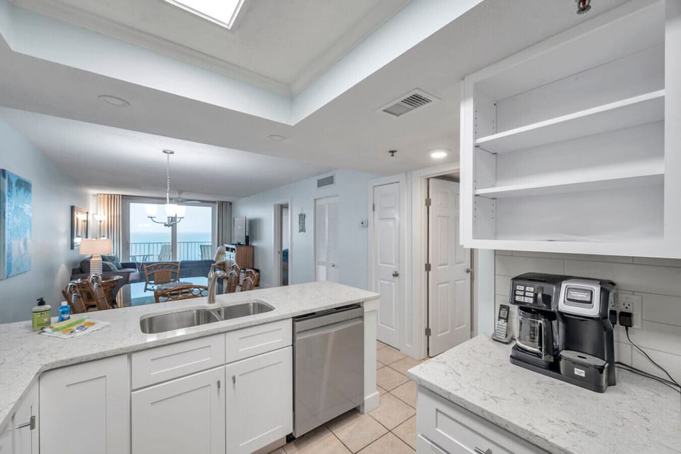 Kitchen coffee nook w/ open shelving & counter space for morning routines.
