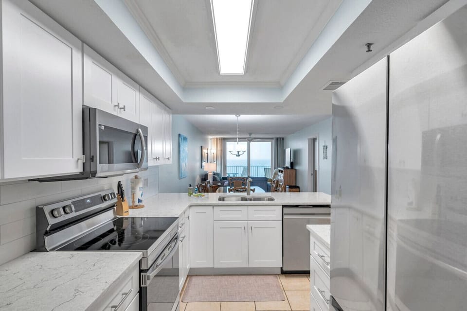 Clean, contemporary kitchen layout offering a bright & functional cooking space.