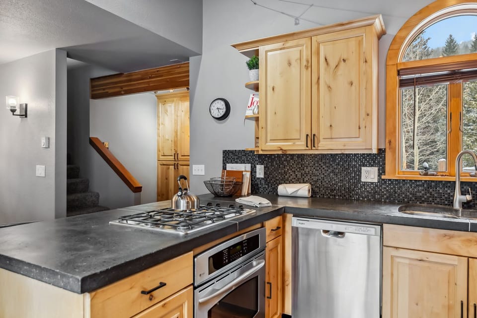 Kitchen: Main floor, drip coffee maker, Keurig, toaster, cooking utensils, tableware