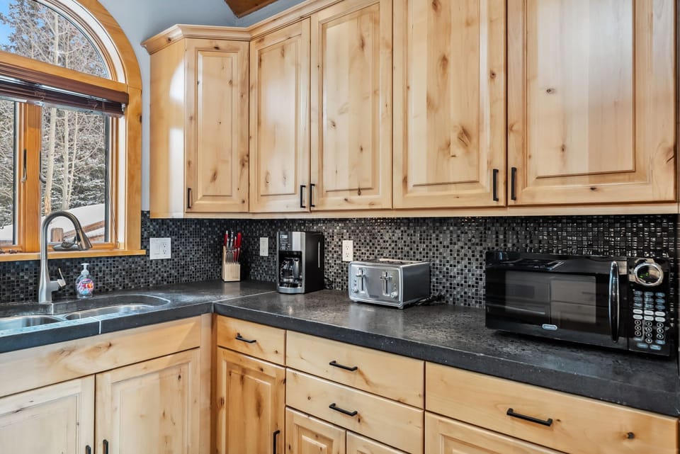 Kitchen: Main floor, drip coffee maker, Keurig, toaster, cooking utensils, tableware