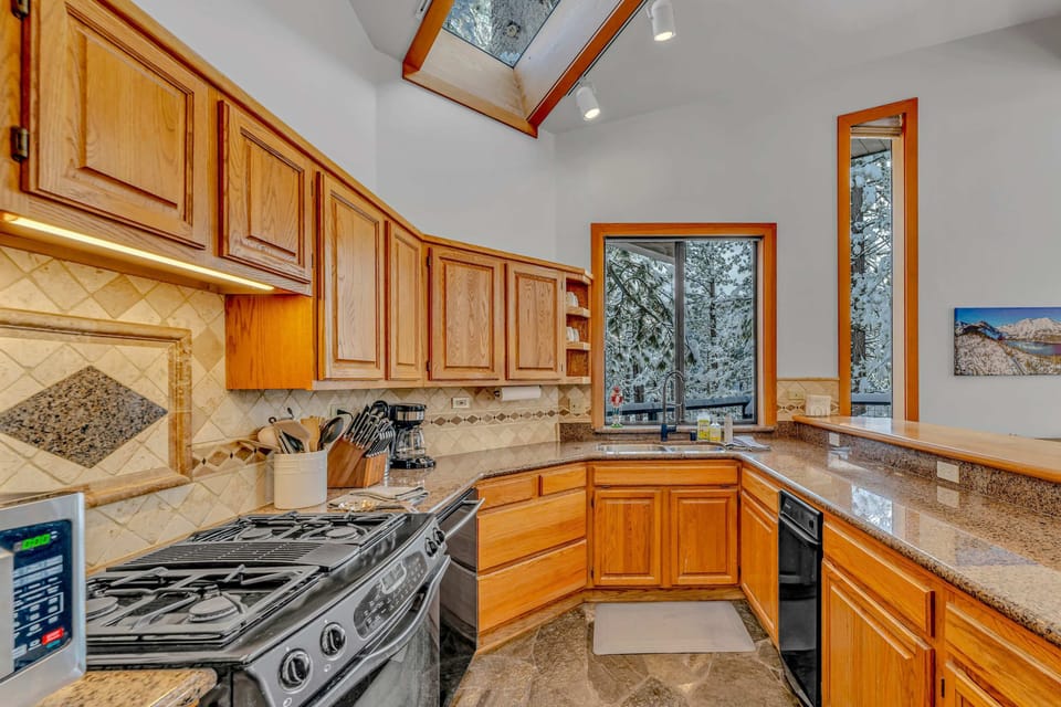 Kitchen: Main floor, drip coffee maker, Crockpot, toaster, cooking utensils, tableware, 4 barstools