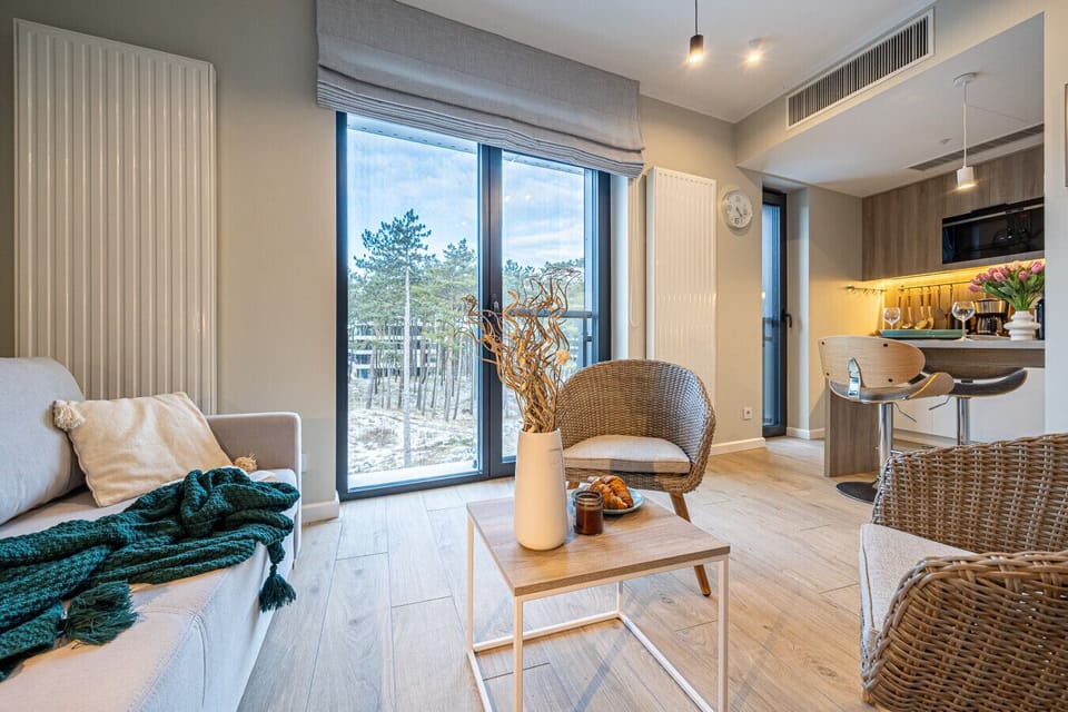 Spacious apartment with forest and sea views – Large windows and natural materials bring the beauty of nature indoors.