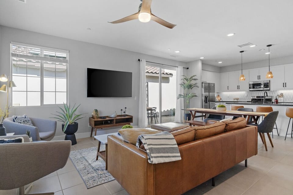 Spacious open living area flowing into kitchen, ideal for gathering & relaxing
