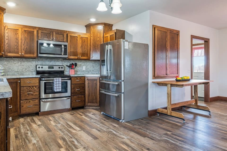 A well-organized kitchen with plenty of counter space and a sleek fridge makes meal prep a breeze.