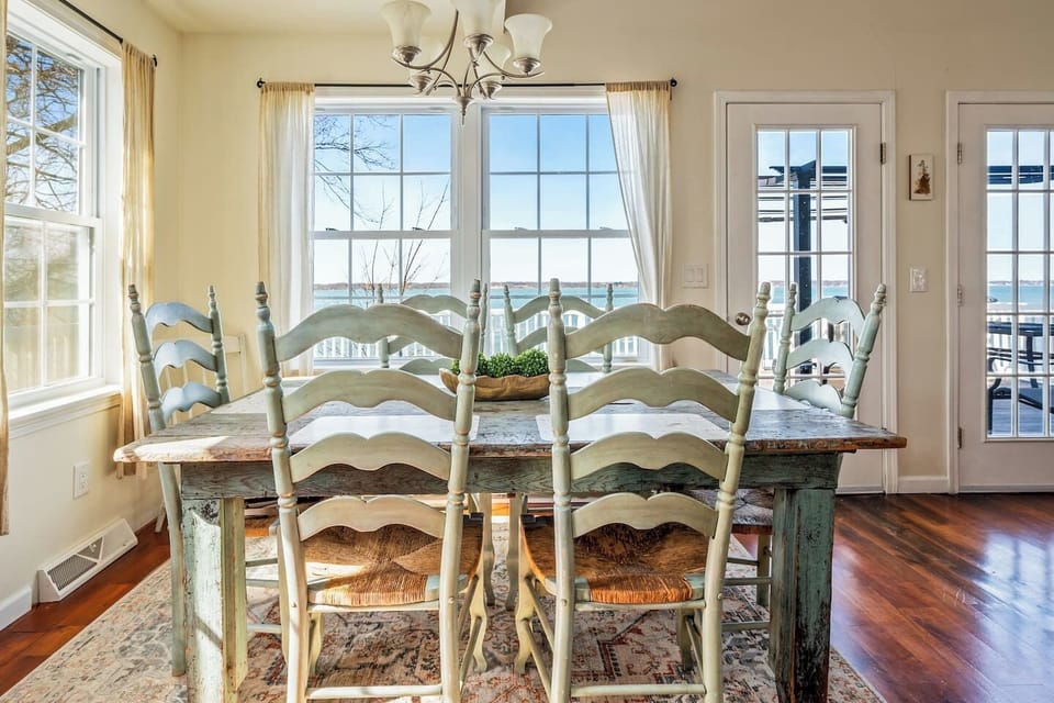 Gather around this rustic farmhouse-style dining table while taking in stunning lake views. The perfect spot for meals, board games, and memorable moments! "Lake House"