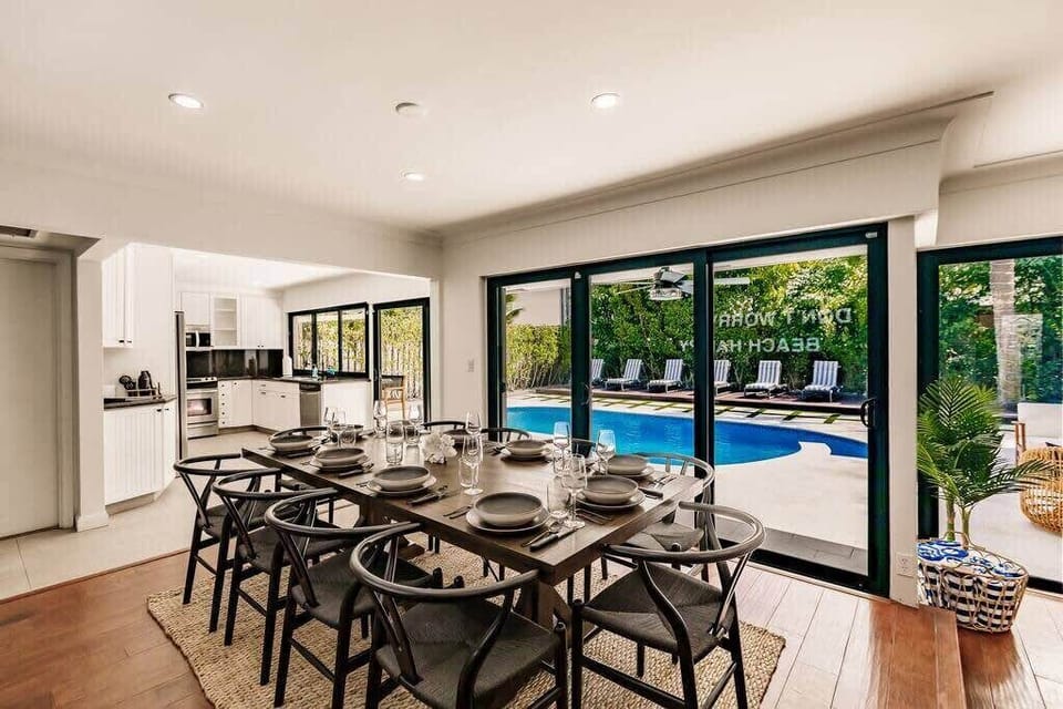 Dining table for 10 with wonderful pool views with the floor to ceiling glass doors.