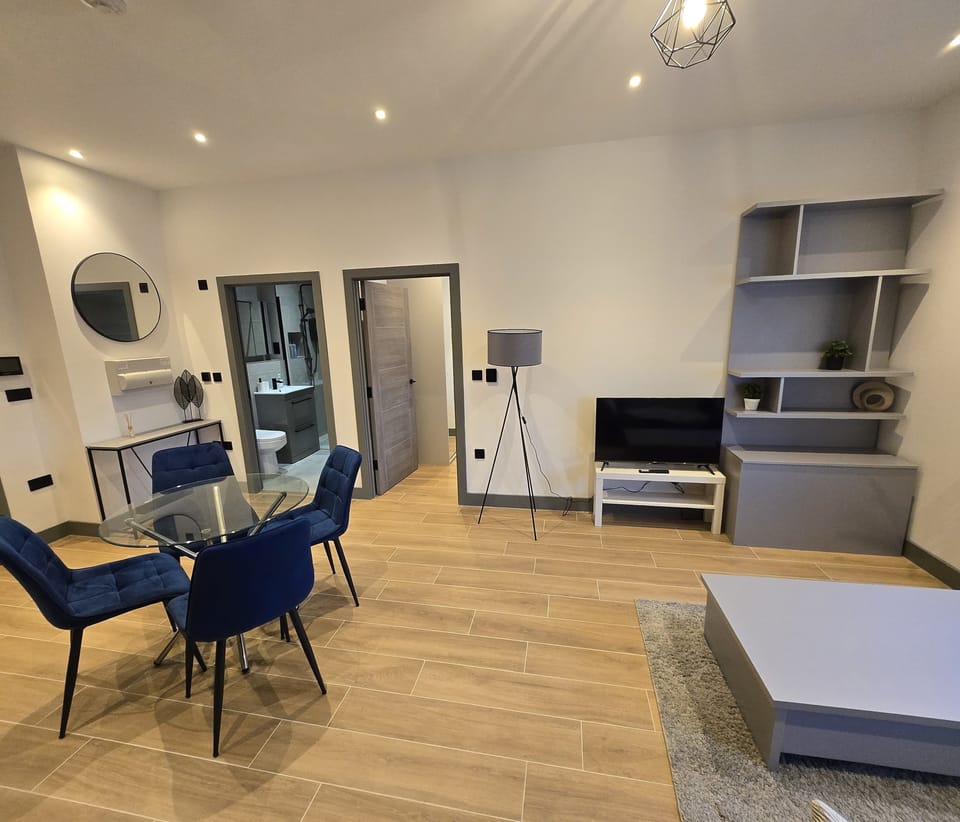 Deluxe Apartment, City View | Living area | 34-inch flat-screen TV with digital channels